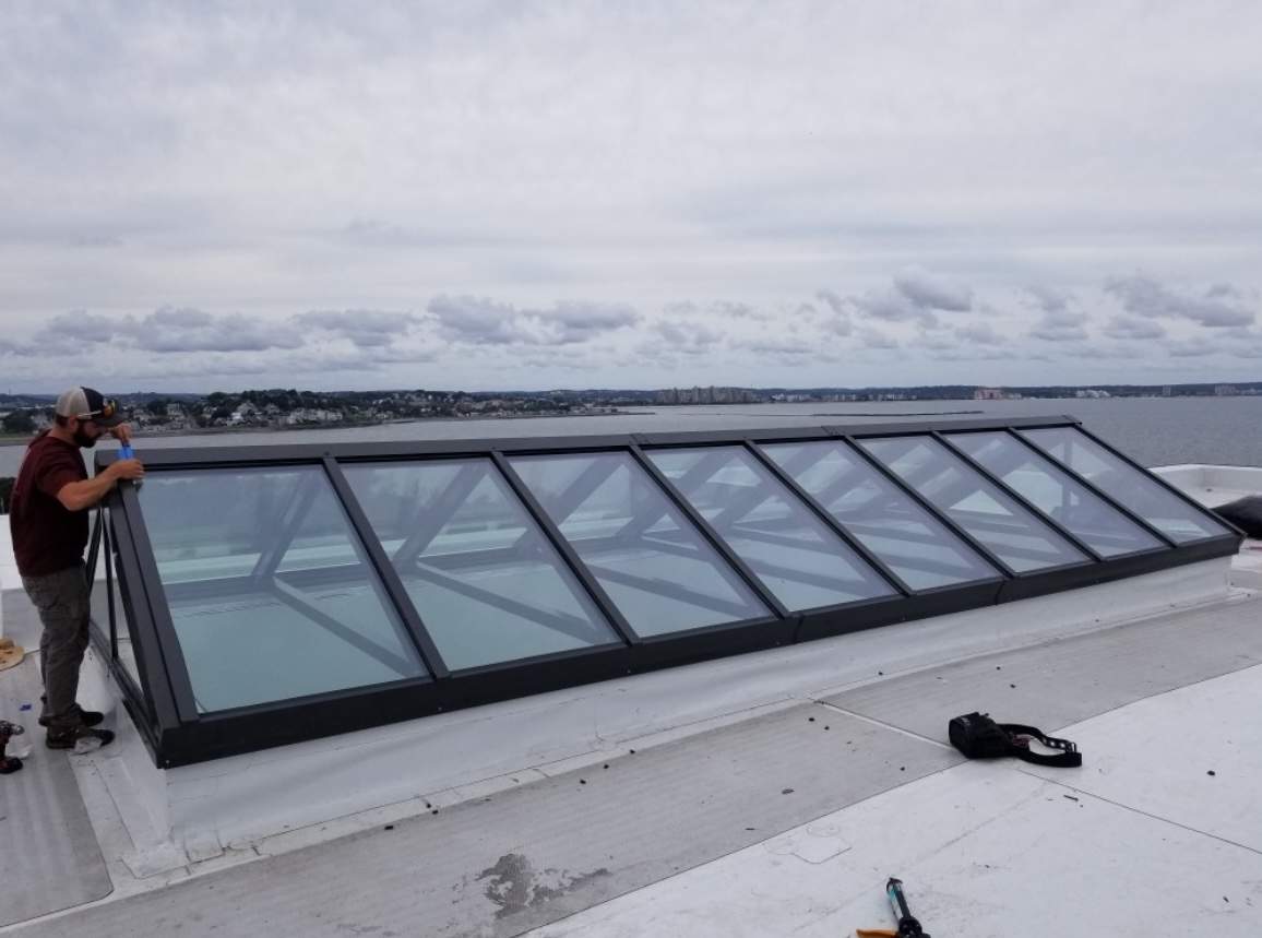 services-01 Long VELUX metal-framed commercial skylight spanning a flat roof in Rhode Island