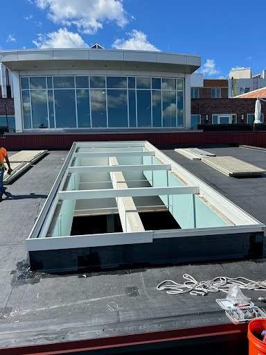 get-in-touch Large VELUX metal-framed commercial skylight mid-installation on a flat roof in Rhode Island, no crew visible